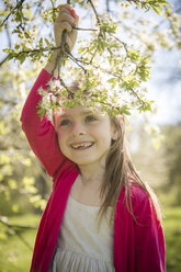 Portrait of smiling girl holding blossoming twig - SARF001741