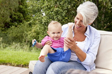 Happy grandmother with baby girl outdoors - MFRF000199