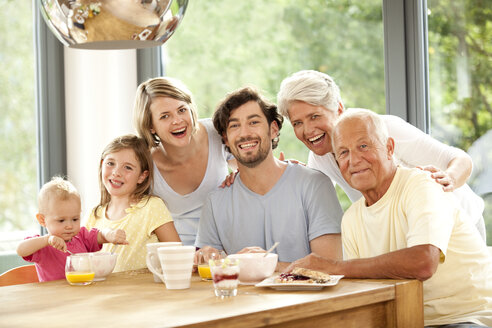 Portrait of happy extended family at breakfast table - MFRF000217