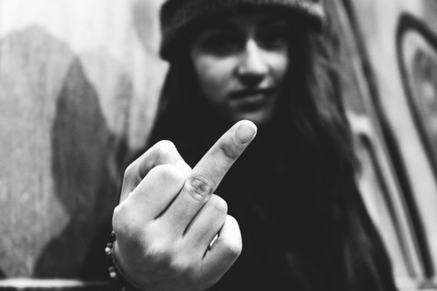 Young woman giving the finger stock photo