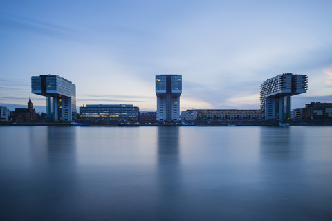 Germany, North Rhine-Westphalia, Cologne, Crane houses at Rheinau harbour in the evening stock photo