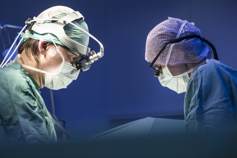 Two surgeons during a surgery stock photo