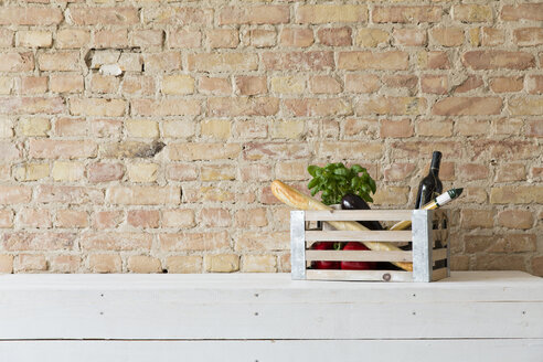 Wooden box with vegetables, pasta, baguette, basil and wine bottle - FKF001032