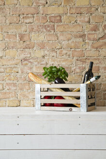 Wooden box with vegetables, pasta, baguette, basil and wine bottle - FKF001033