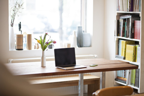 Table with laptop in a modern individual bistro stock photo