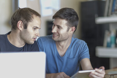 Two men with laptop and digital tablet - ZEF004416