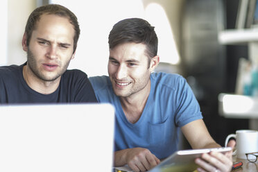 Two men with laptop and digital tablet - ZEF004417