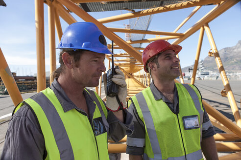 Two workers at port with walkie talkie - ZEF005467