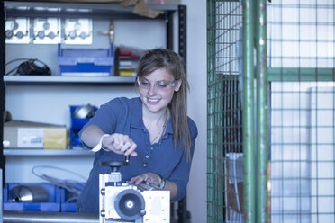 Technician working at machine - SGF001547