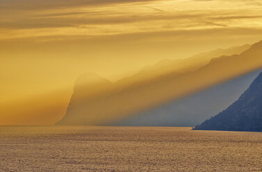 Italy, Torbole, Lake Garda with mountains at sunset - MRF001626