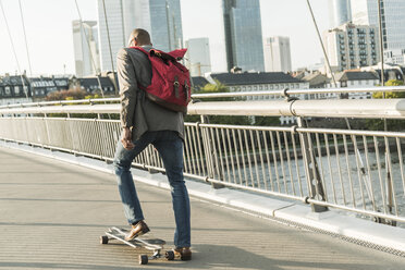 Deutschland, Frankfurt, Mann fährt Skateboard auf Brücke - UUF004046