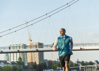 Germany, Frankfurt, man jogging by the riverside - UUF004079