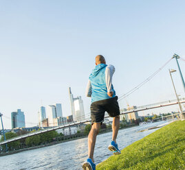 Germany, Frankfurt, man jogging by the riverside - UUF004051