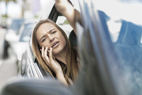 Frustrated teenager in car stuck in traffic jam - ZEF004905
