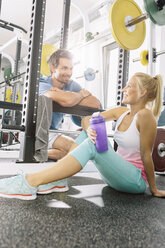 Junges Paar entspannt sich nach dem Training im Fitnessstudio - MADF000205