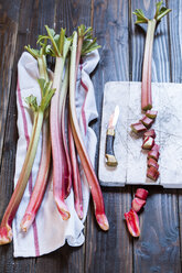 Rhubarb stalks, cut in pieces, board and knife - SBDF001818