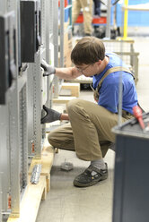 Worker in a switchboard construction factory - LYF000414