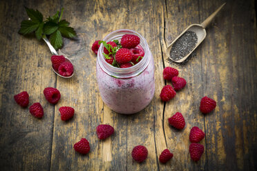Raspberries, chia, milk, kiwi, hemp seed and mint in a glass - LVF003319