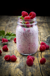 Raspberries, chia, milk, kiwi, hemp seed and mint in a glass - LVF003320