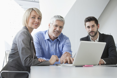 Businesspeople in informal meeting discussing new strategies stock photo