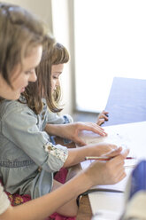 Mother and daughter drawing at home - ZEF004834