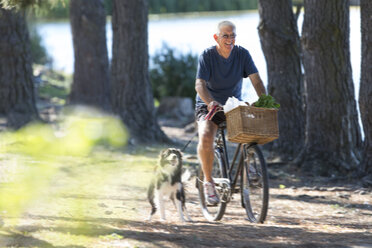 Senior man riding bicycle - ZEF004738