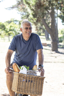 Smiling senior man on bicycle - ZEF004947