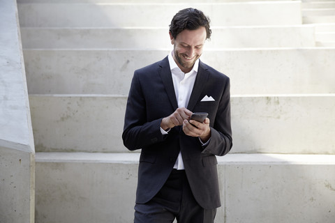 Businessman using smartphone in a modern building stock photo