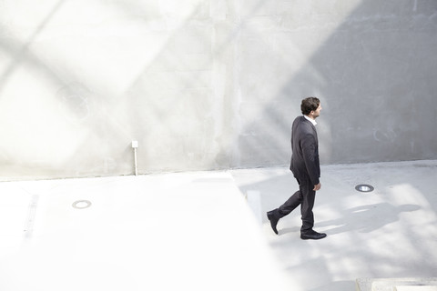 Businessman walking in a modern building stock photo