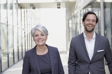 Portrait of two smiling business people - FMKF001542