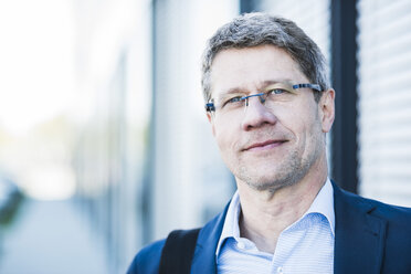 Germany, Portrait of a mature businessman in street - UUF004081