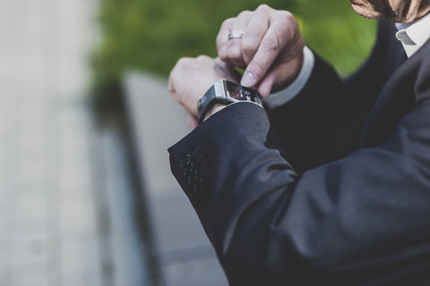 Businessman checking smart watch stock photo