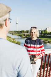 Deutschland, Mannheim, Älteres Paar auf Brücke, Blick über die Schulter des Mannes - UUF004136