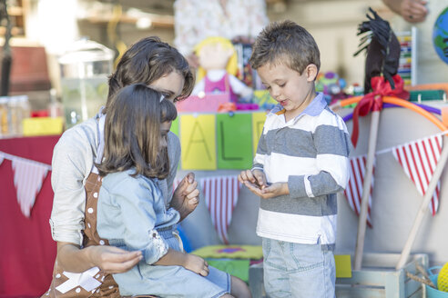 Kinder beim Flohmarkt, die mit ihrer Mutter Geld zählen - ZEF004882