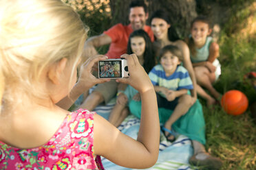 Mädchen fotografiert Familie am Baum - TOYF000249