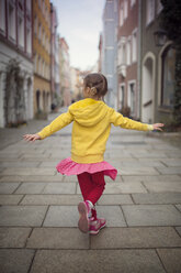 Germany, Bavaria, little girl dancing in an alley - OPF000054
