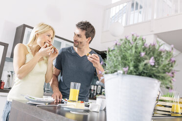 Couple having breakfast in the kitchen at weekend - MADF000270