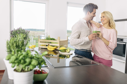 Couple drinking smootie in the kitchen stock photo