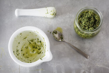 Glass of homemade parsley pesto and empty mortar - EVGF001711