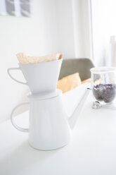 White coffee filter on coffee pot on a table - FLF001011