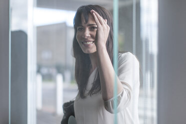 Woman looking through window - ZEF005844