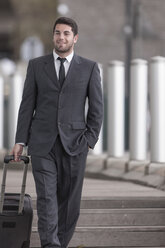 Portrait of businessman with suitcase - ZEF005849