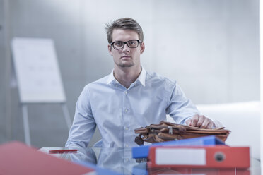 Portrait of young businessman at his desk - ZEF005398