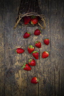 Wickerbasket of strawberries on dark wood - LVF003356