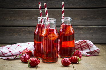 Three glass bottles of homemade strawberry lemonade - LVF003362