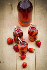 Glass bottles of homemade strawberry lemonade - LVF003365