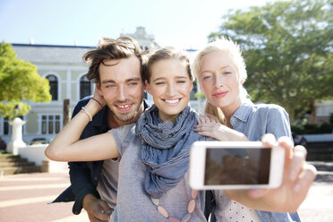 Happy friends outdoors taking a selfie - TOYF000538