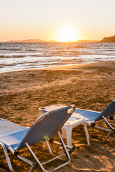 Greece, Corfu, sun loungers at Arillas beach in the evening - EGBF000060