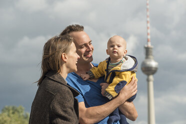 Germany, Berlin, happy couple with baby boy in front of television tower - FBF000392