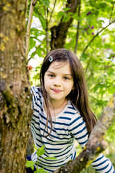 Portrait of girl climbing in a tree - LVF003388